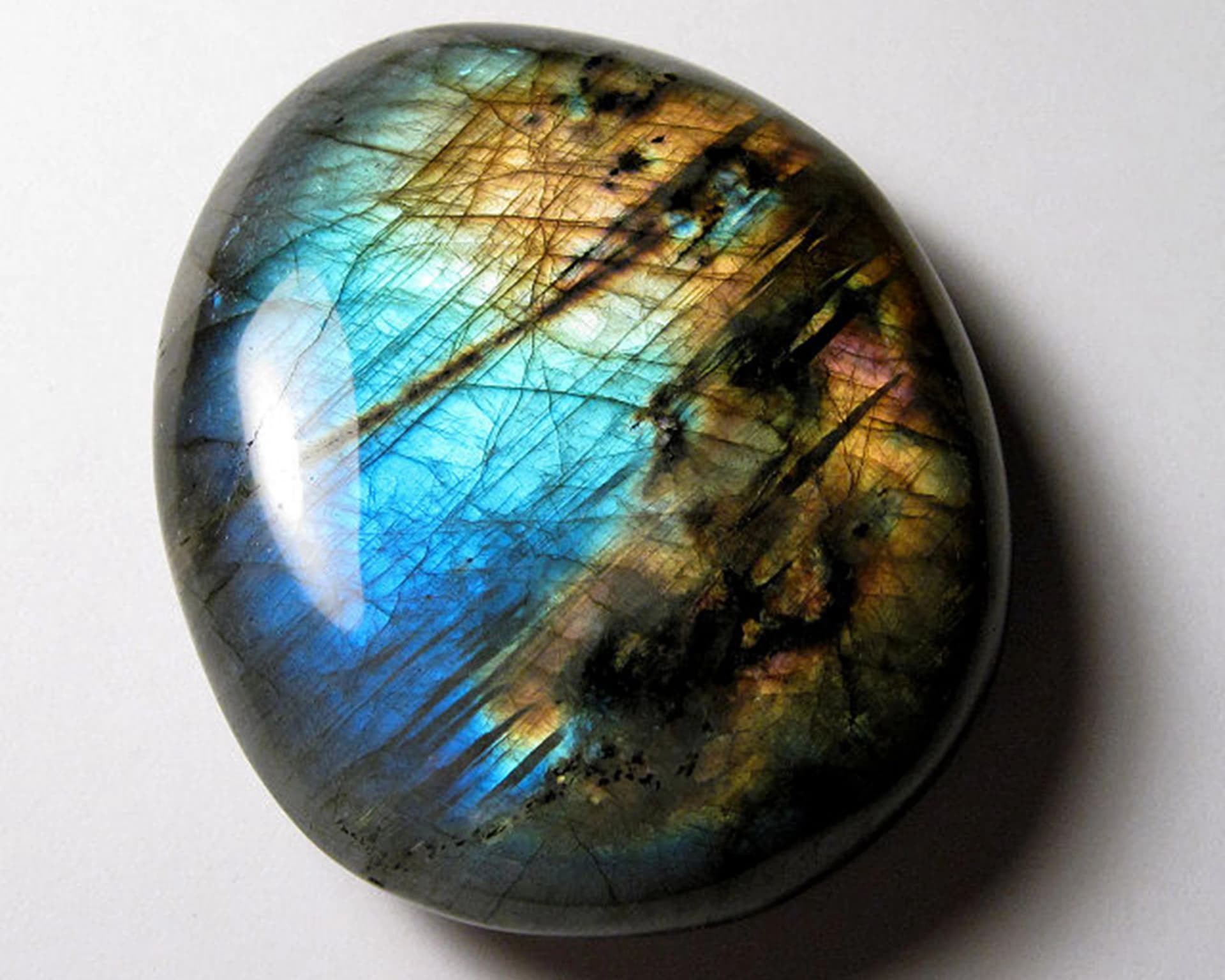 Polished labradorite stone flashing blue and gold iridescence