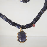 Iolite pendant on a blue necklace