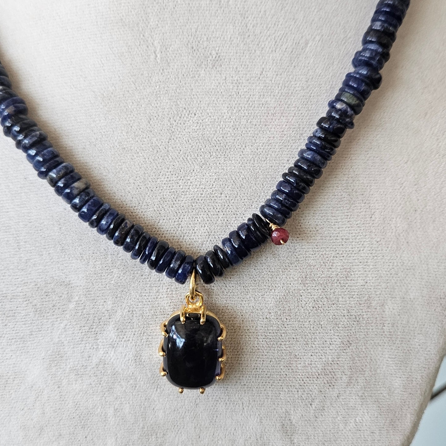 Iolite pendant on a blue necklace