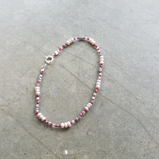 Pearls on red string bracelet